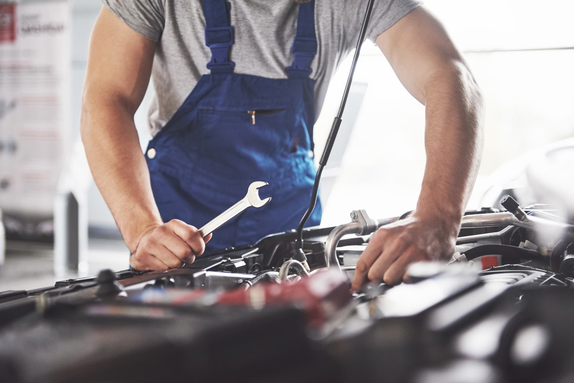 Auto repair technician working on a vehicle
